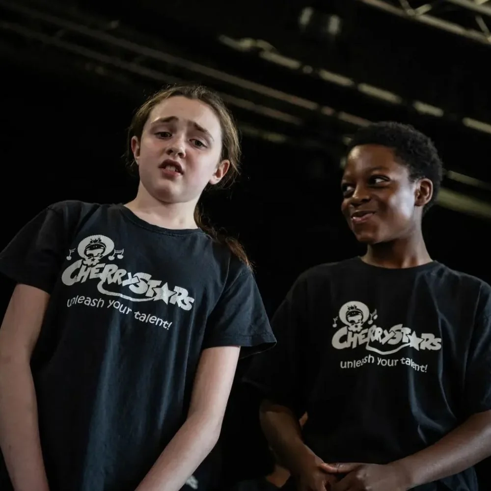 Two Cherry Stars students wearing the official Cherry Stars T-shirt